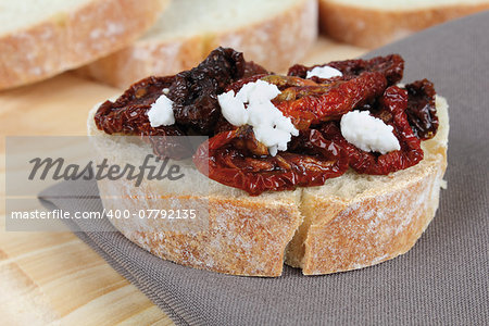 closeup of bread with dried tomatoes and cheese