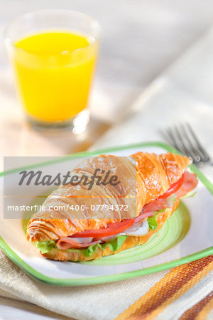 croissant with salad, ham and tomatoes