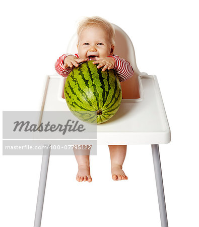 Little baby is trying to eat watermelon. Isolated on white.