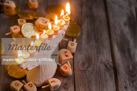 Jewish holiday hannukah symbols - menorah and wooden dreidels. Copy space background.