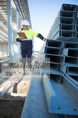 Site manager checking girders on construction site