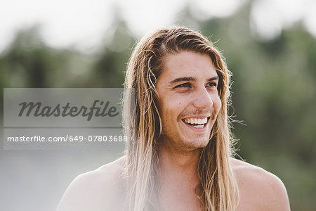 Man in long hair with wide smile