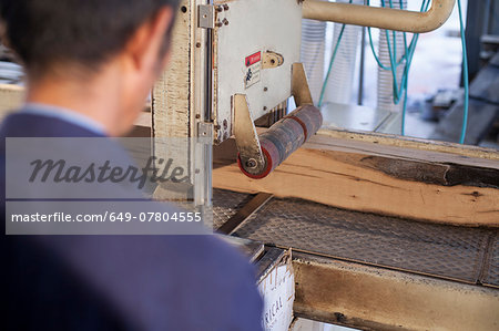 Carpenter working on wood flooring in factory, Jiangsu, China