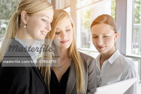 Businesswomen sharing information on digital tablet