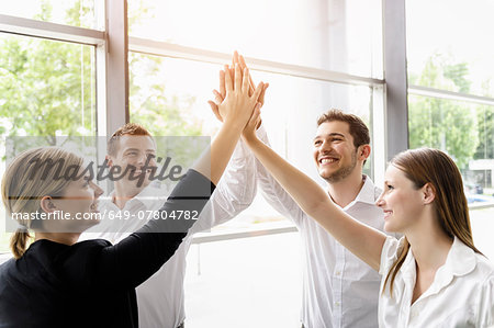 Businessmen and businesswomen cheering