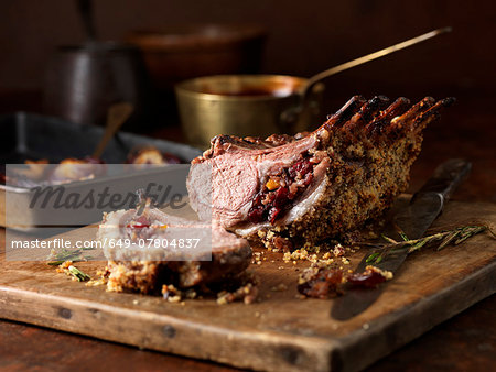 Christmas dinner. Lamb rack rare medium with cranberry and clementine stuffing and rosemary