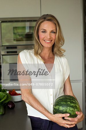 Mature woman holding watermelon