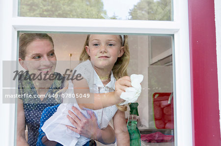 Mother and daughter cleaning window