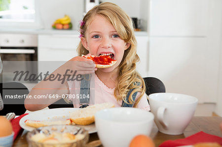 Girl eating at kitchen table