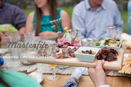 Family having meal together, outdoors