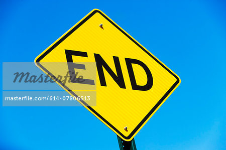 Yellow road sign against blue sky with word - end