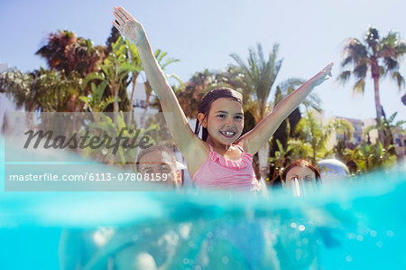 Parents with daughter playing in swimming pool