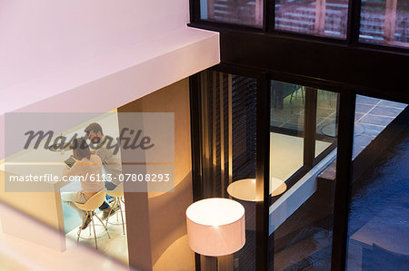 Elevated view of couple using tablet pc in dining room