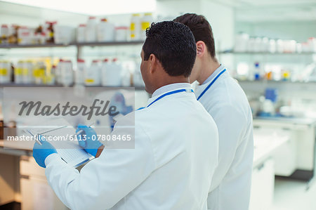 Scientists taking notes in laboratory