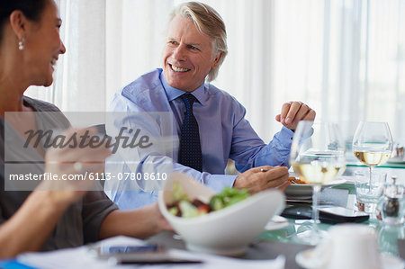 Smiling business people having lunch in restaurant