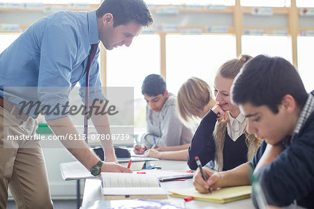 Teacher helping his students in classroom Teacher helping his students in classroom