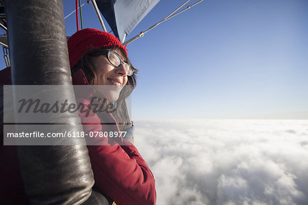 Woman travelling in a hot air balloon.
