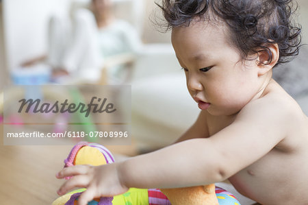 Baby boy playing indoors.