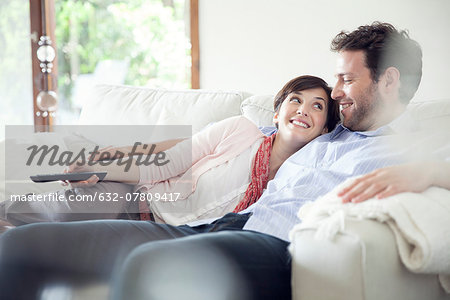 Couple watching TV together on sofa