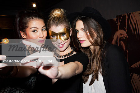 Young women at night club taking selfie