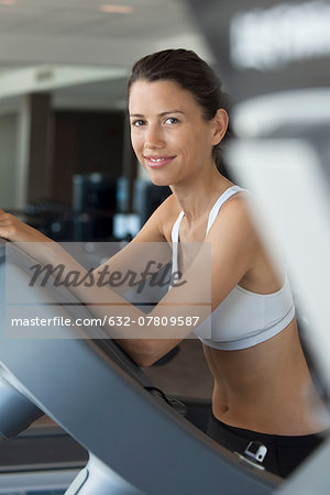 Woman exercising in health club, portrait