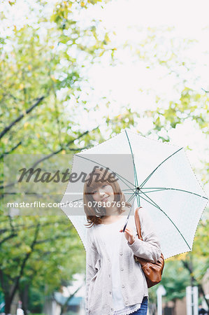 Portrait of young Japanese woman in a park