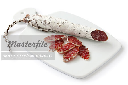 fuet calidad, spanish moldy salami on white cutting board