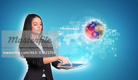 Beautiful businesswomen in suit using digital tablet. Earth with world map, graphs and network. Element of this image furnished by NASA