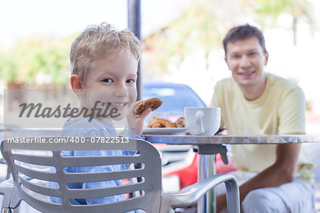 family of two enjoying desserts at outside cafe