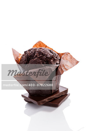 Chocolate muffin isolated on white background with reflection. Culinary sweet dessert eating.