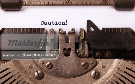 Vintage inscription made by old typewriter, caution