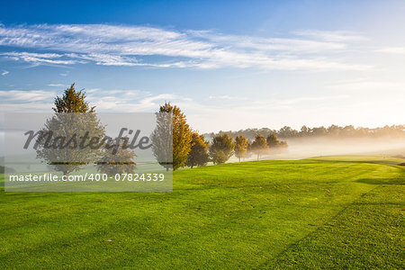 On the empty golf course in the morning mist