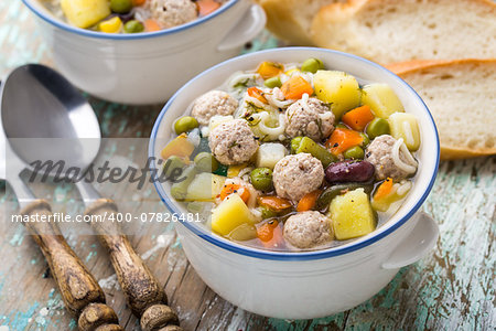 Delicious meatball soup with vegetables in a bowl