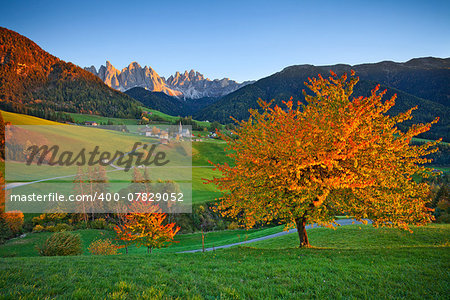 Beautiful St. Magdalena village in a gorgeous Funes Valley located in Italian Alps during autumn sunset.