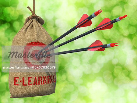 E-Learning - Three Arrows Hit in Red Target on a Hanging Sack on Green Bokeh Background.