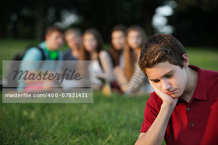 Sulking male caucasian teen with face in hands
