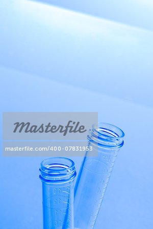 empty test tubes in laboratory on table and blue light tint background