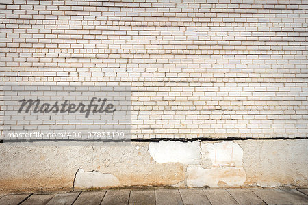 White brick wall and a side walk