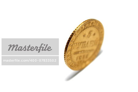 old gold coin isolated on a white background closeup