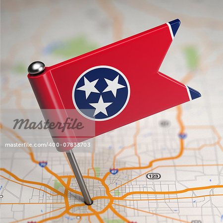 Small Flag of Tennessee on a Map Background with Selective Focus.