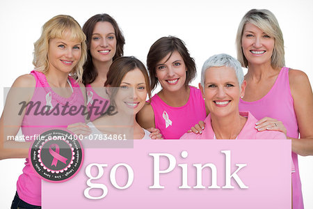 Smiling women posing and wearing pink for breast cancer against pink card