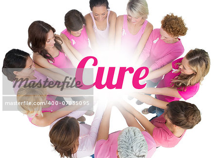 Cheerful women joined in a circle wearing pink for breast cancer on white background