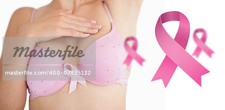 Woman in bra with breast cancer awareness ribbon against pink breast cancer awareness ribbons
