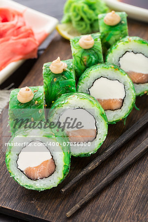 Salmon sushi rolls covered with chuka seaweed