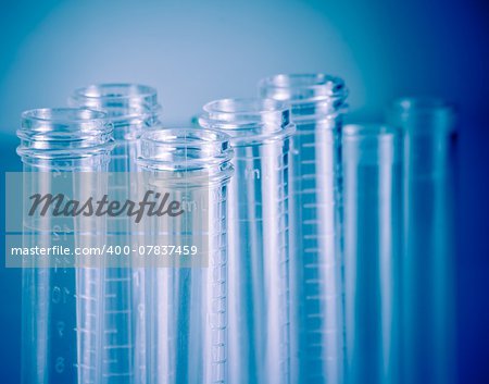 detail of the test tubes in laboratory on blue light tint background