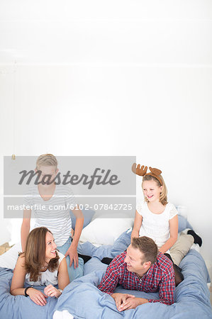 Family relaxing in bed