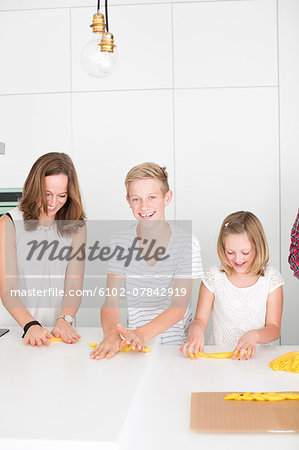 Mother and kids preparing saffron rolls