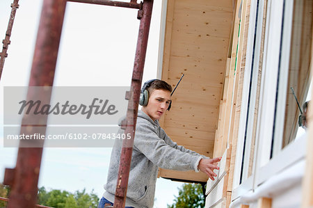 Young man building house