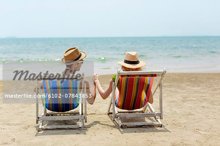 Smiling couple on lounge chairs