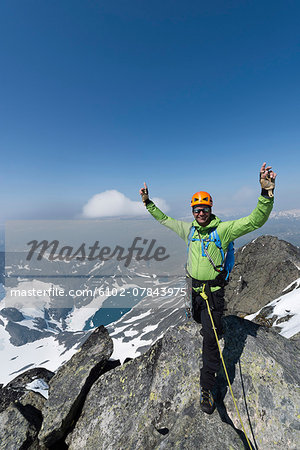 Smiling man on top of mountain